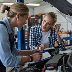 woman leading a mentoring session in an automotive service center