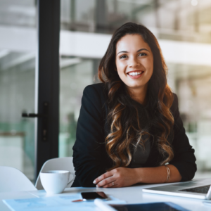 happy woman sitting at desk