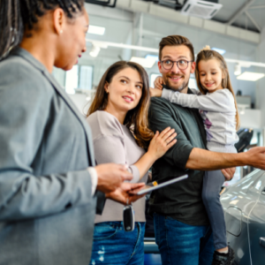 woman in automotive sales working with a family to find their perfect car