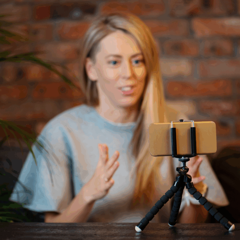 Woman recording a selfie video in an office, demonstrating confidence and authenticity in personal branding