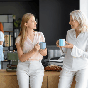 Two women mentors sharing coffee and conversation, symbolizing informal mentorship.