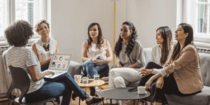 Diverse women leaders and mentees meeting through the Women In Automotive mentorship program.