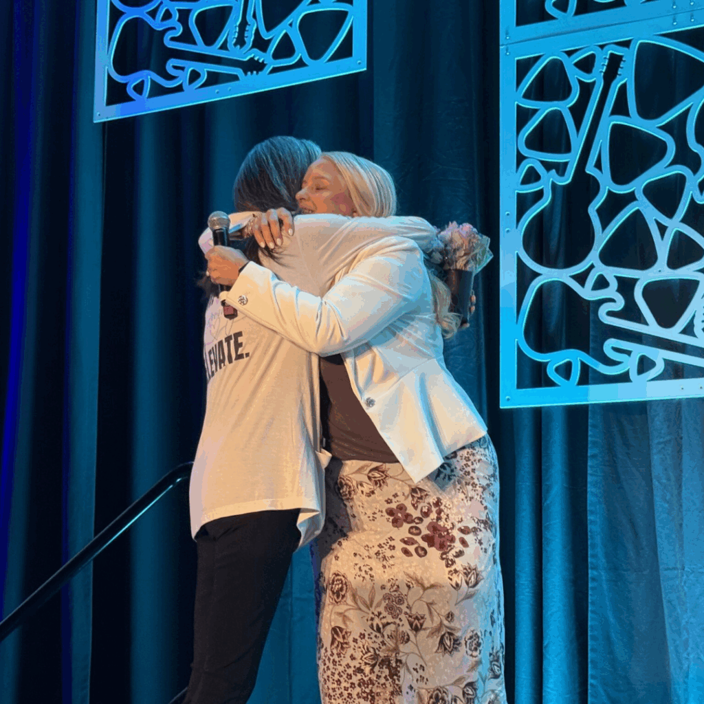 Veronica Dunford hugging speaker after talk at WIA, symbolizing supportive community