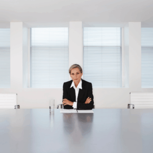 Woman reflecting alone in a corporate setting, representing early career challenges without mentorship.